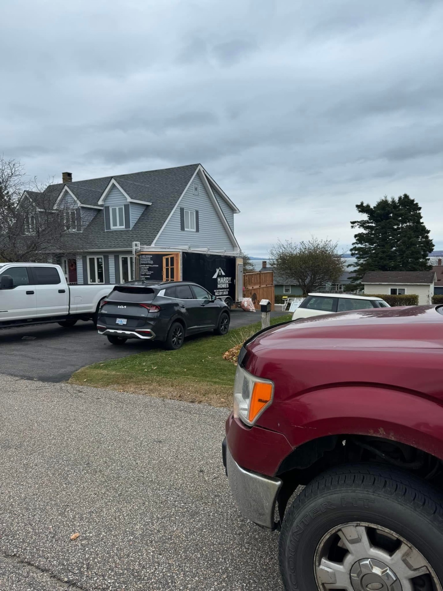 Hardy Homes trailer and truck on-site at an oceanview home