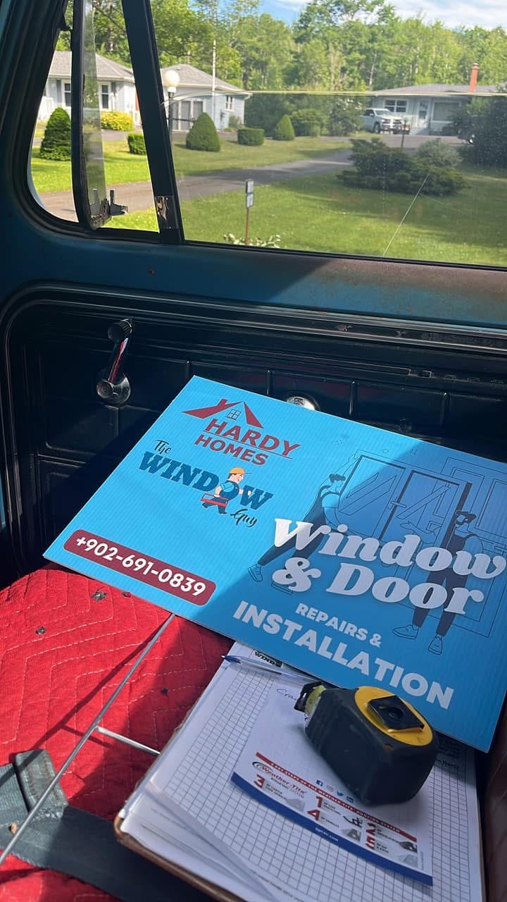Hardy Homes window and door installation sign in a work truck
