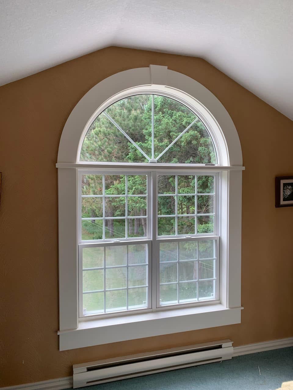 Completed arched window with finished white trim